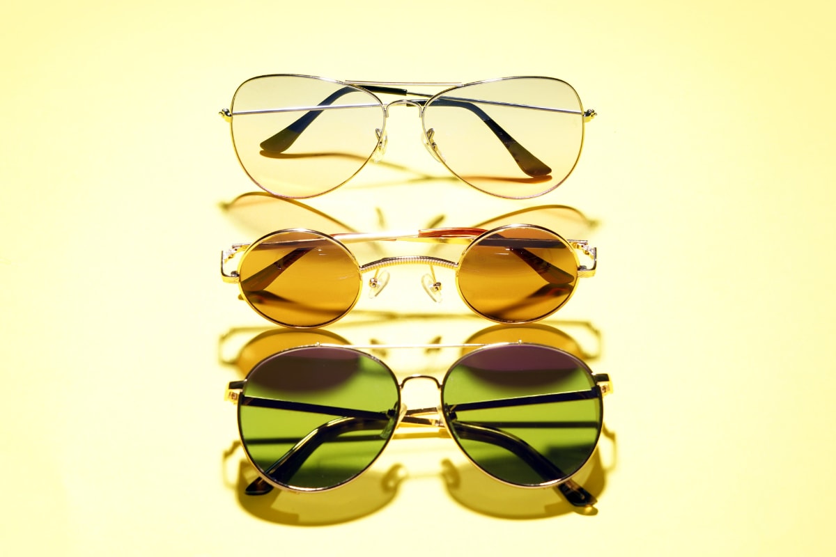 different-stylish-sunglasses-on-color-background
