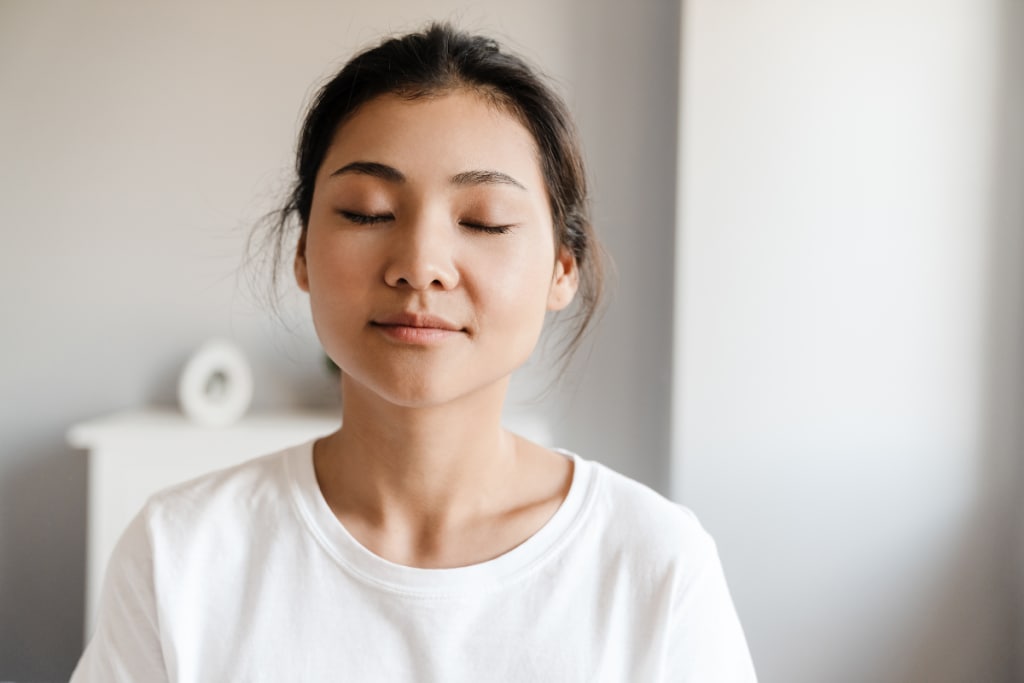 close-up-of-a-smiling-young-asian-woman-relaxing