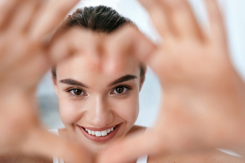 beautiful-woman-face-with-heart-shaped-hands