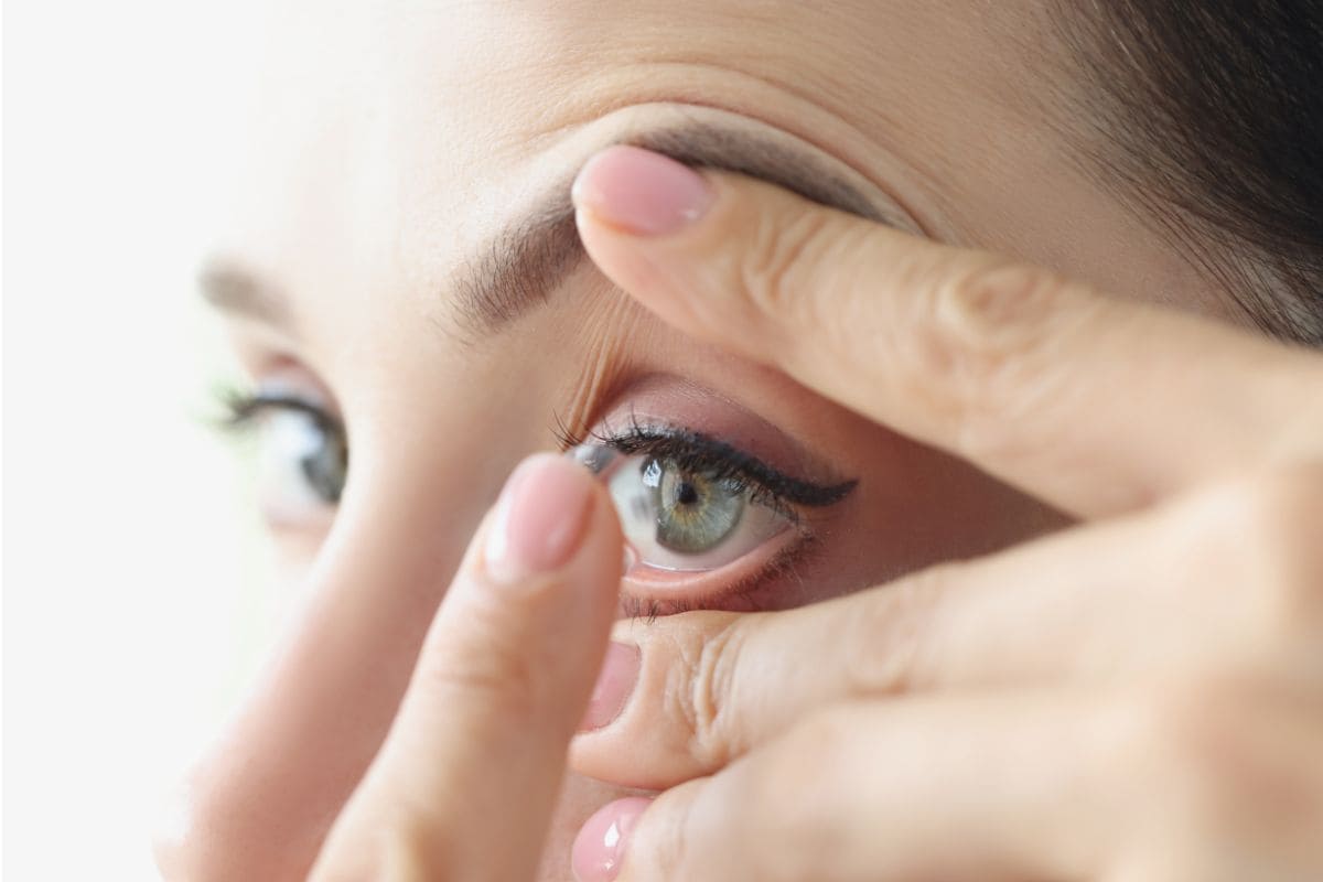 woman-puts-on-soft-contact-lenses-closeup