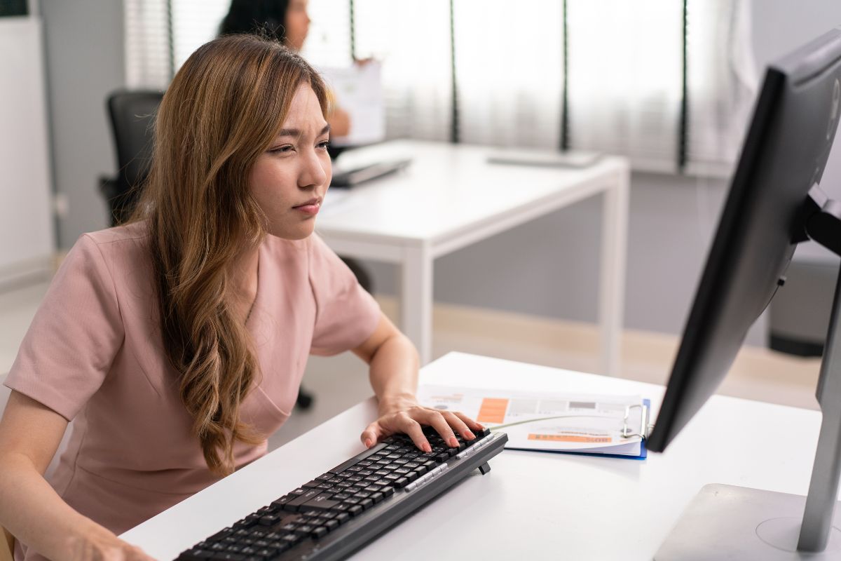 asian-female-employee-having-farsighted-problem-looking-at-monitor