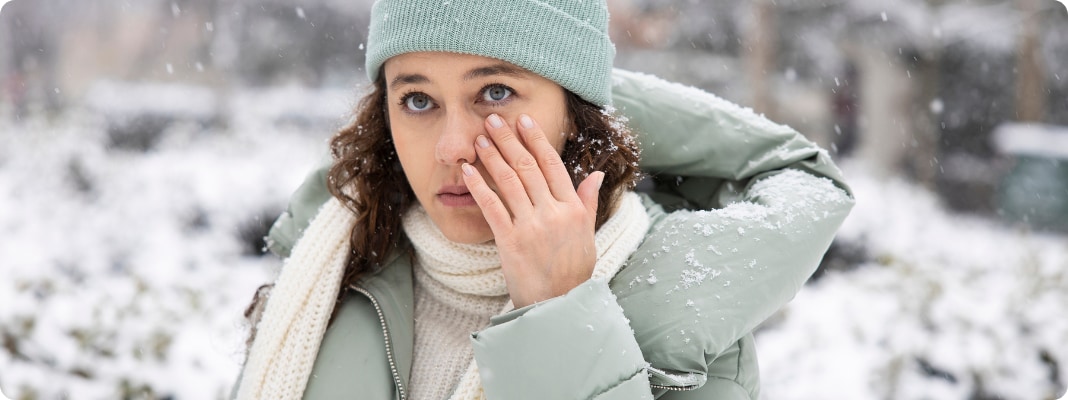 woman-in-winter-touching-her-eye