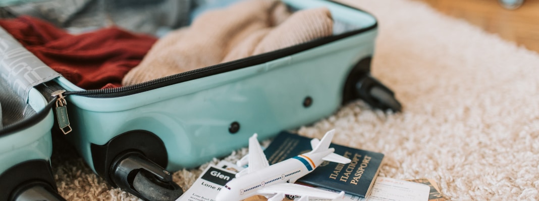 green-luggage-bag-on-carpet